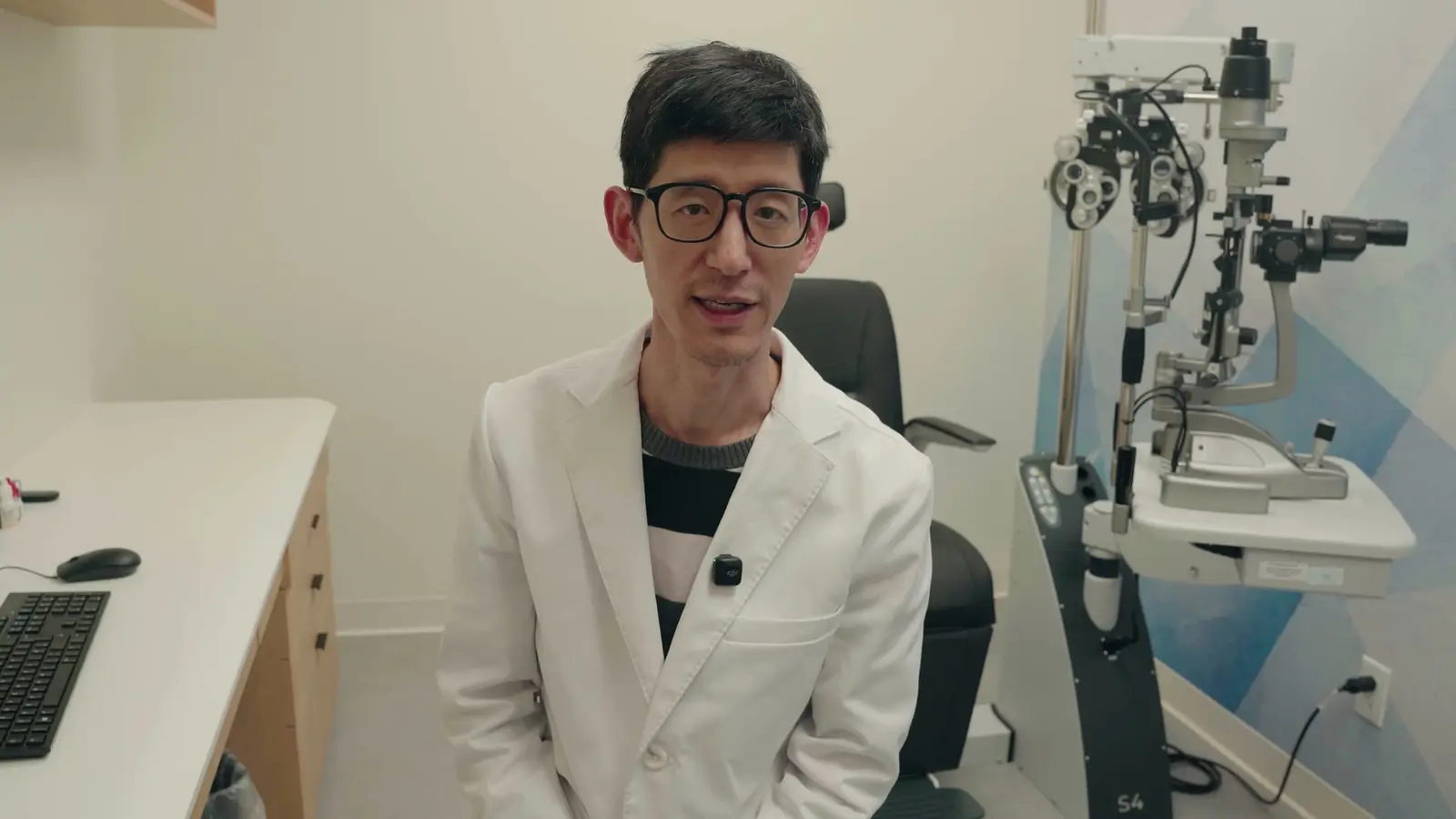 Dr. Walter Liao in a Claye exam room beside the slit lamp