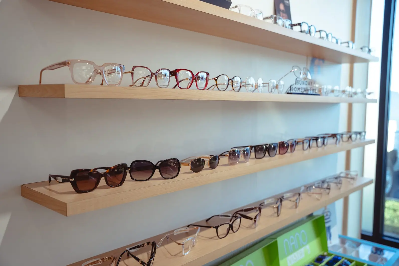 Sunglasses on oak shelves by the window