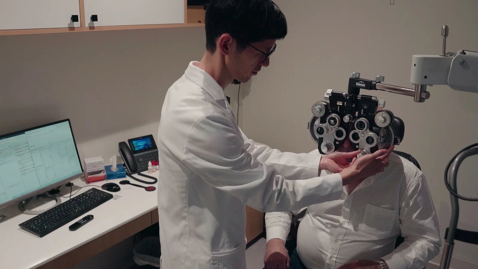 Dr. Walter Liao at the phoropter in a Claye exam room